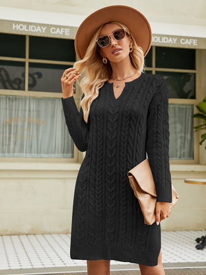 Black cable knit sweater dress with keyhole neckline and long sleeves.