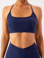Dark blue ribbed halterneck active bra with a square neckline.