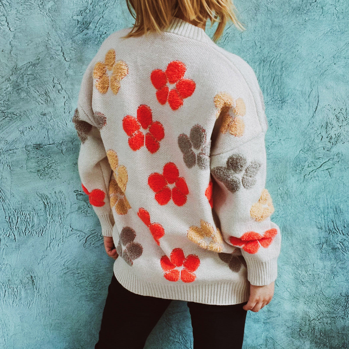 Ivory knit cardigan with embroidered floral pattern, crew neck, and long sleeves.