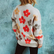 Ivory knit cardigan with embroidered floral pattern, crew neck, and long sleeves.