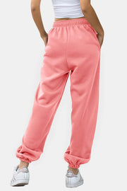 Slouchy sweatpants in Burnt Coral with gathered cuffs and elastic waistband.