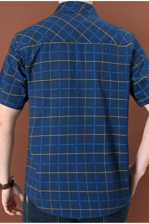 Plaid short sleeve button-down shirt in royal blue cotton blend with a collared neckline.