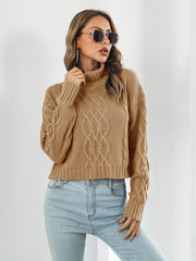 Caramel cable knit cropped turtleneck sweater with chunky knit details.