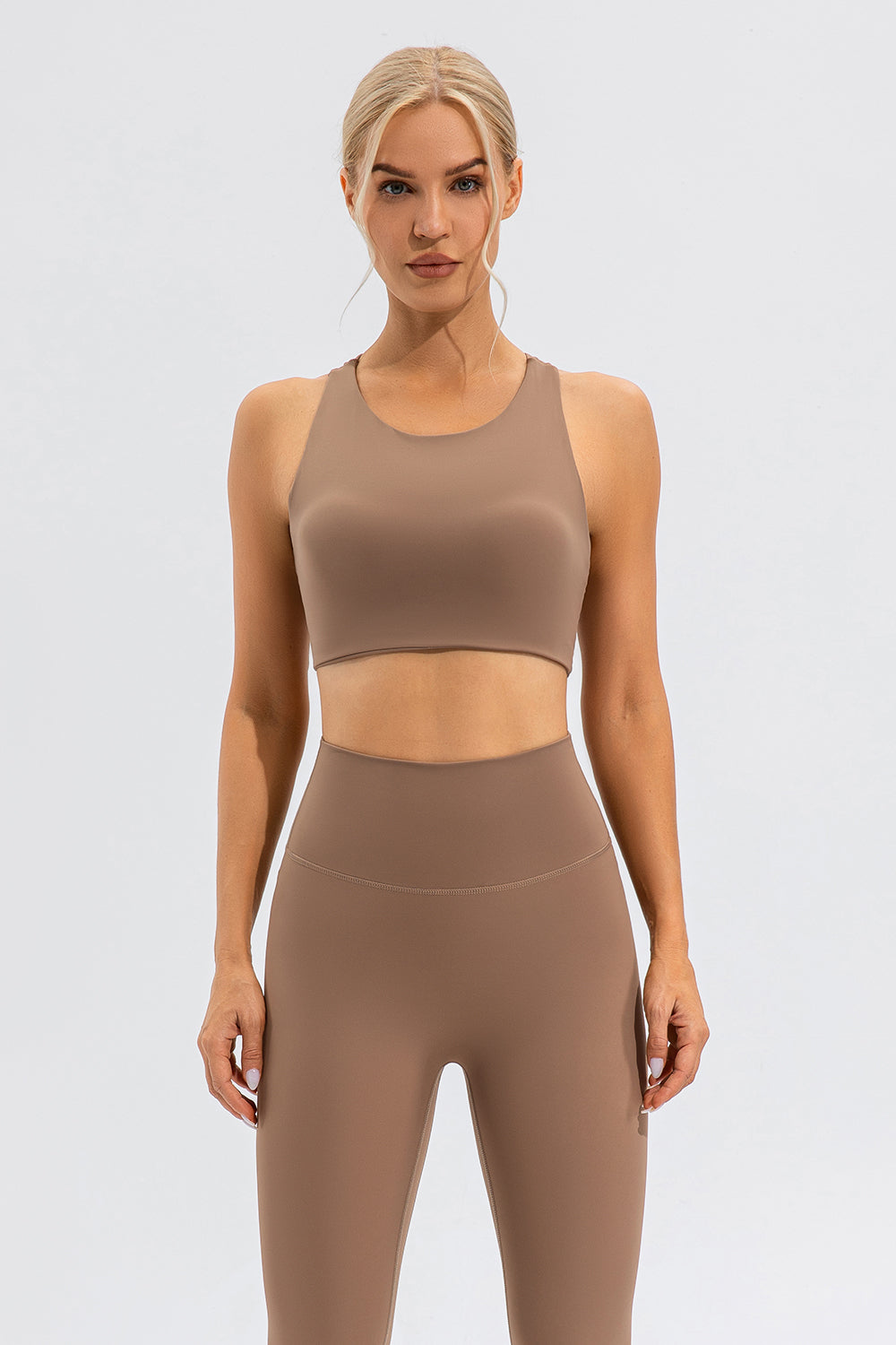 Camel sports bra with asymmetric cutout detail and racerback.