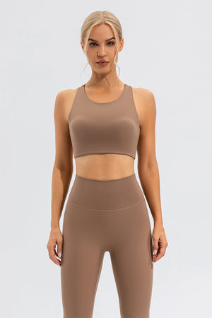Camel sports bra with asymmetric cutout detail and racerback.