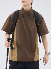 Brown and tan colorblock pullover activewear top with quarter zip and short sleeves.