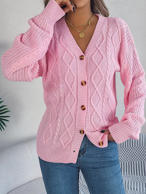 Blush pink cable knit balloon sleeve cardigan with button front and v-neck.