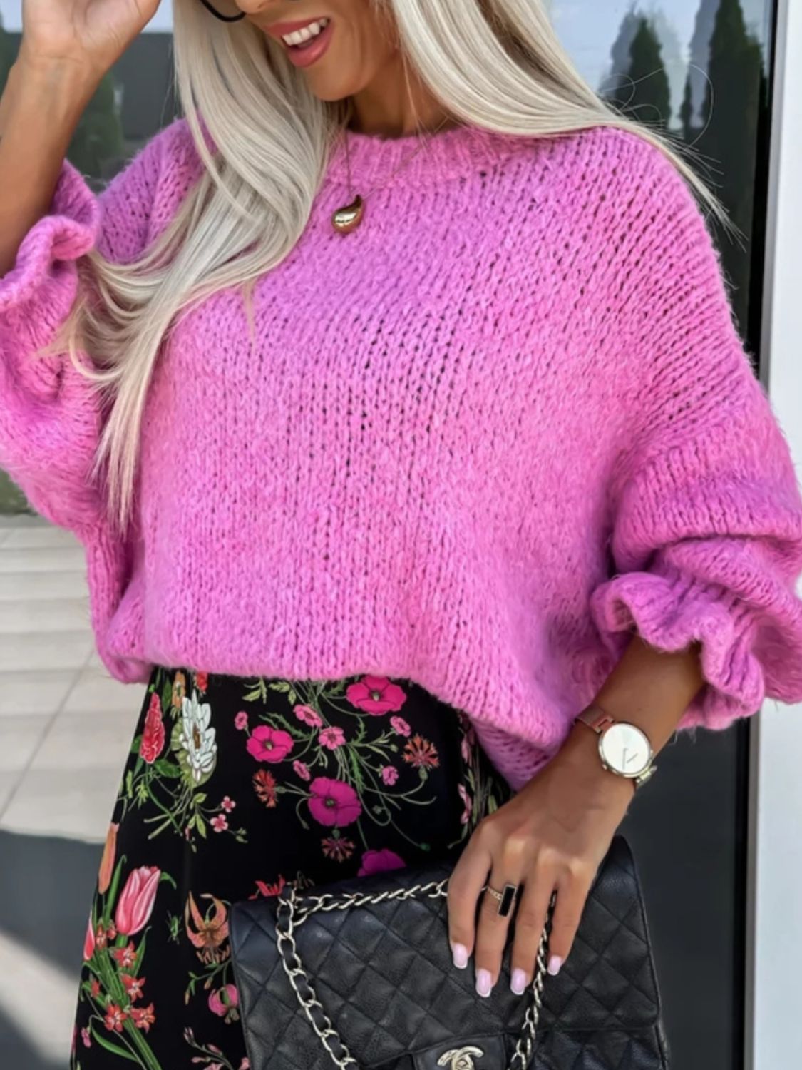 Fuchsia pink knit sweater with voluminous ruffled sleeves and crewneck.