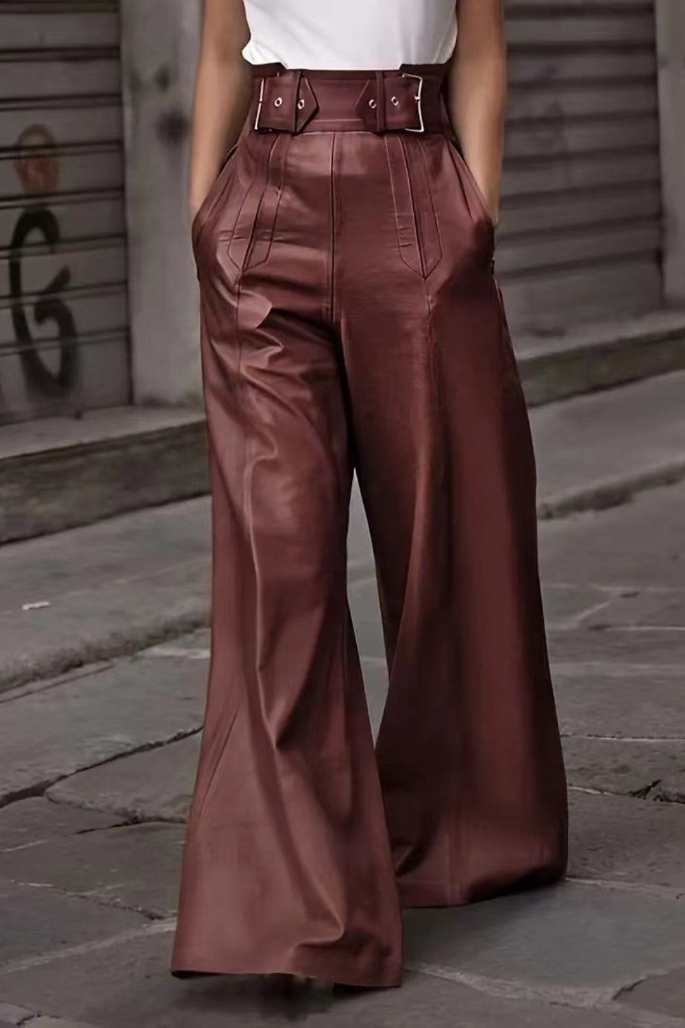 Burgundy wide-leg leather pants with a buckle belt and pleats