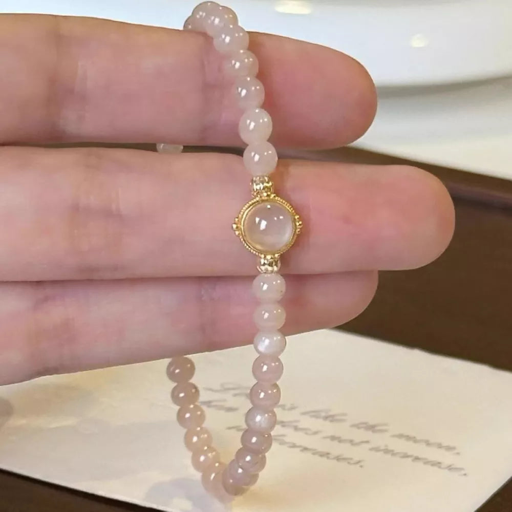 Gold-plated bracelet with blush pink moonstone beads and a central moonstone cabochon.