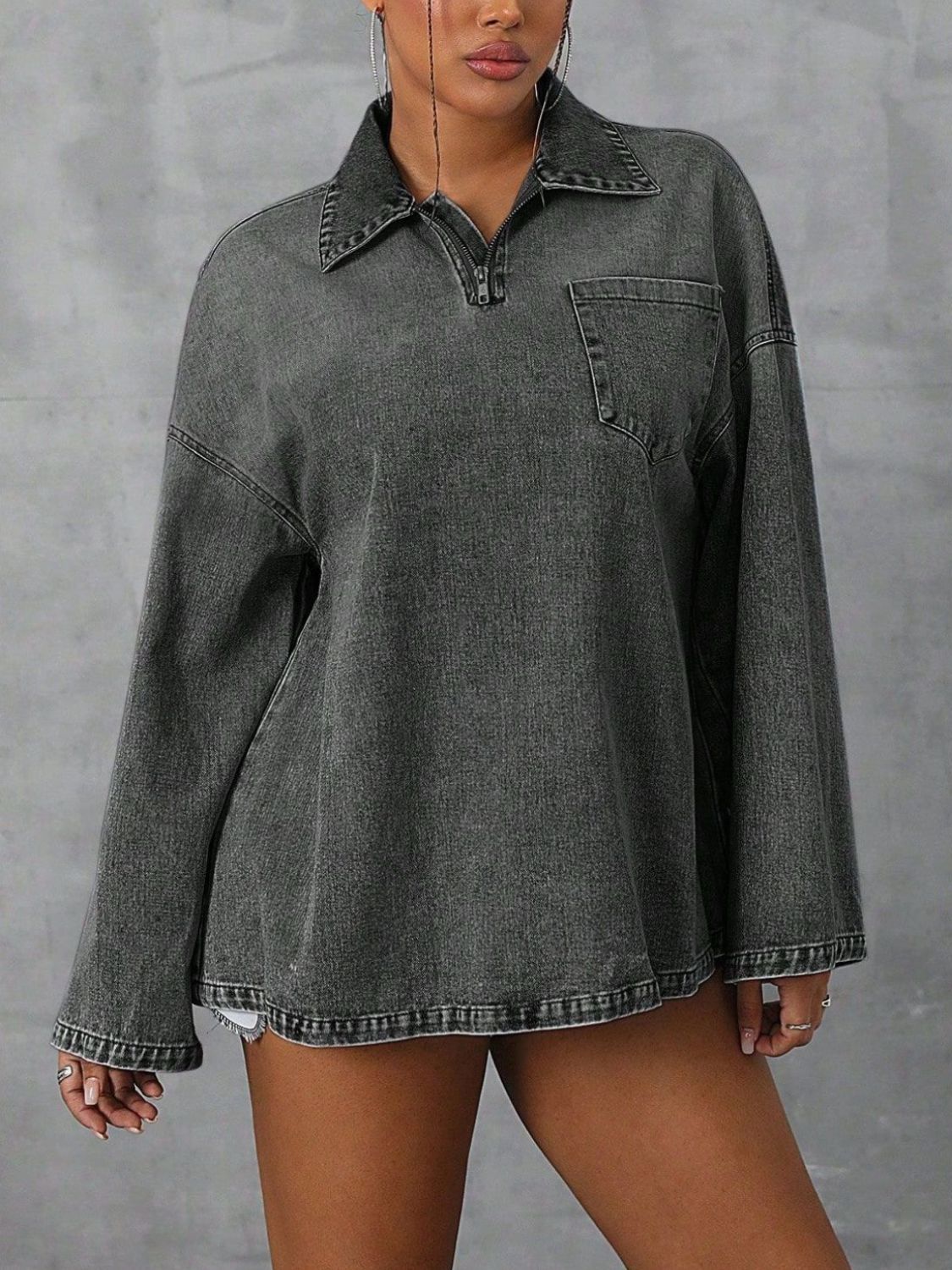 Oversized dark denim polo shirt with quarter zip, collared neckline, and chest pocket.