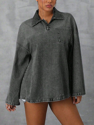 Oversized dark denim polo shirt with quarter zip, collared neckline, and chest pocket.