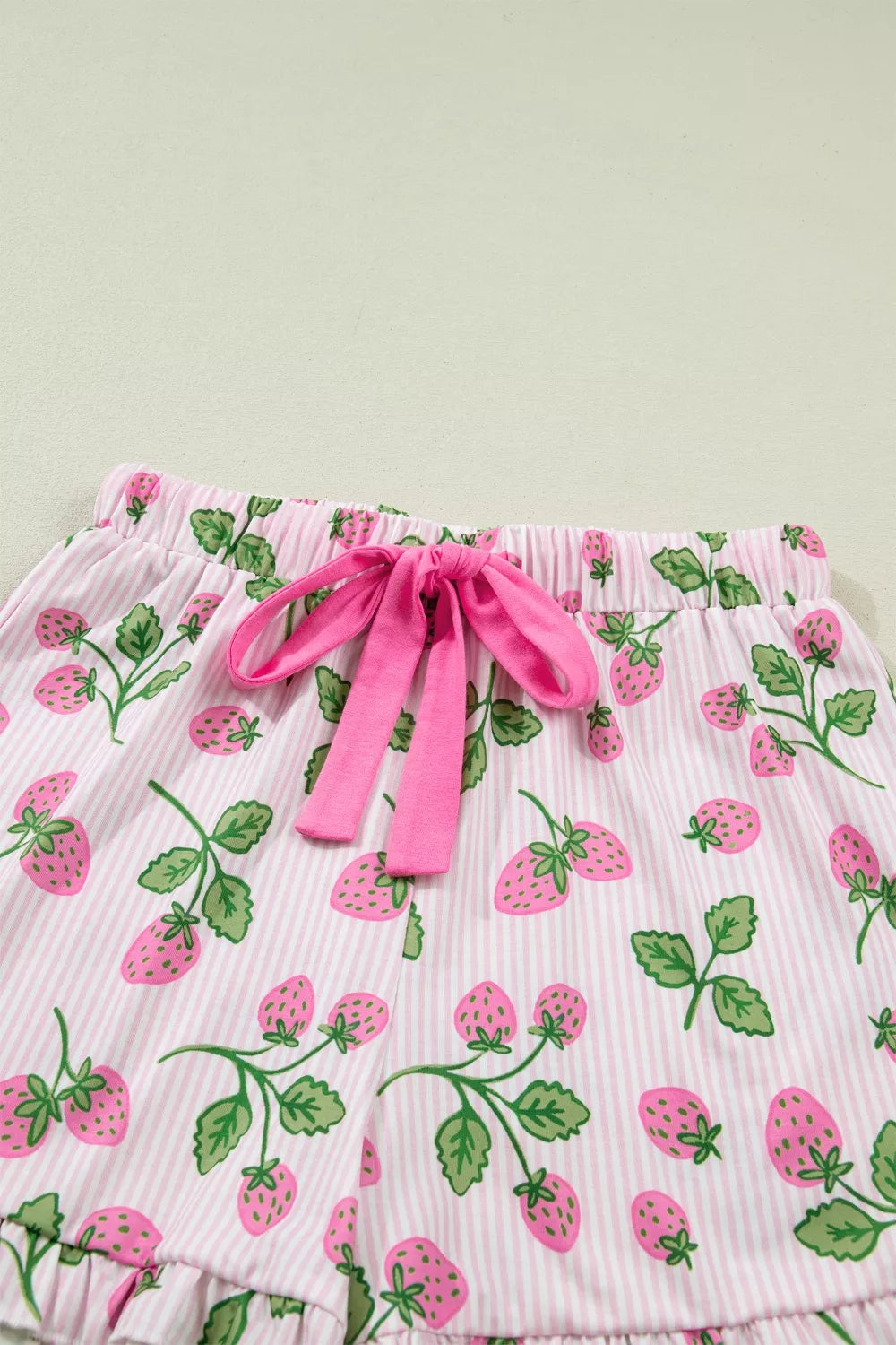 Pink striped pajama shorts with a strawberry print and drawstring waist.