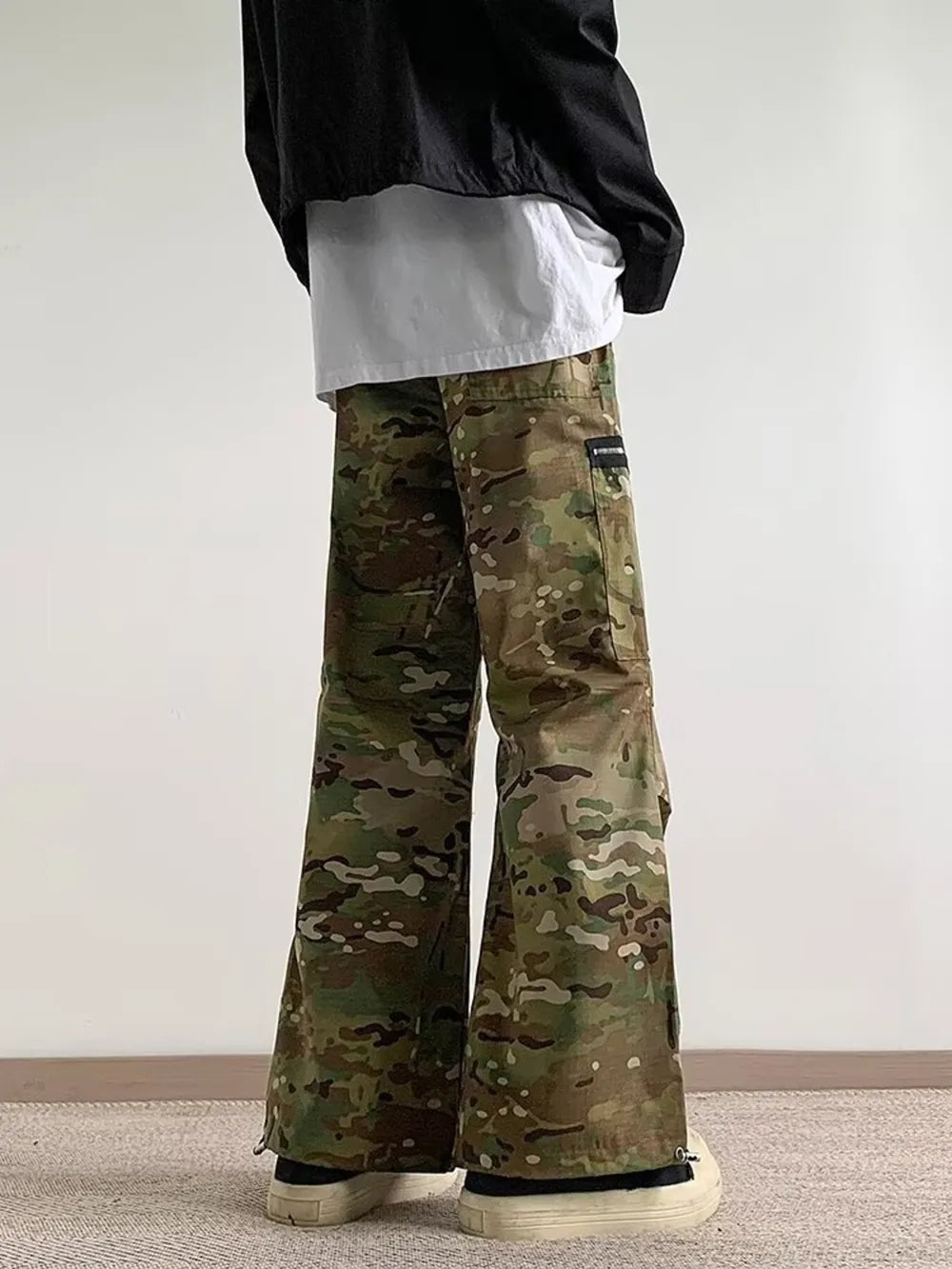 Oversized camouflage cargo pants with zipper pockets and a relaxed fit.