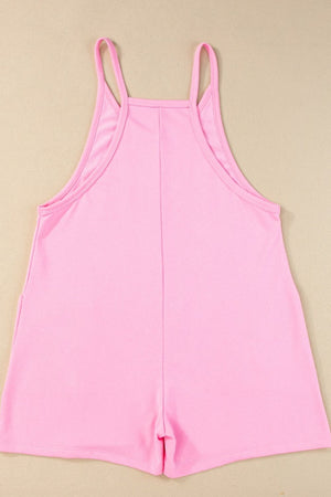 Pink spaghetti strap romper with patch pockets and a square neckline.
