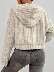 Beige textured teddy zip-up hoodie with a cropped length and ribbed detail.