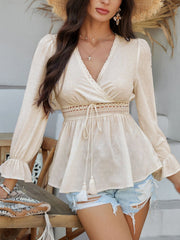 Tan Swiss dot wrap blouse with lace trim and tassel tie detail