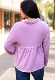 Lilac textured blouse with gathered yoke and collar, long sleeves, and babydoll cut.