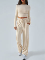 Ribbed knit crop top and wide leg pants set in tan with drawstring waist.