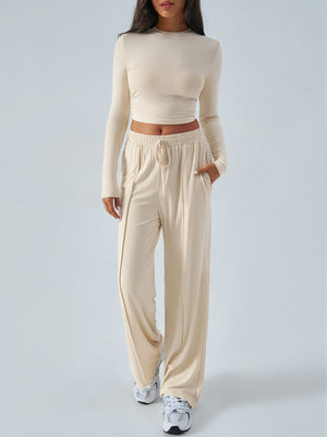 Ribbed knit crop top and wide leg pants set in tan with drawstring waist.