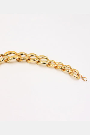 Gold chunky chain belt with acrylic links and a lobster clasp closure.