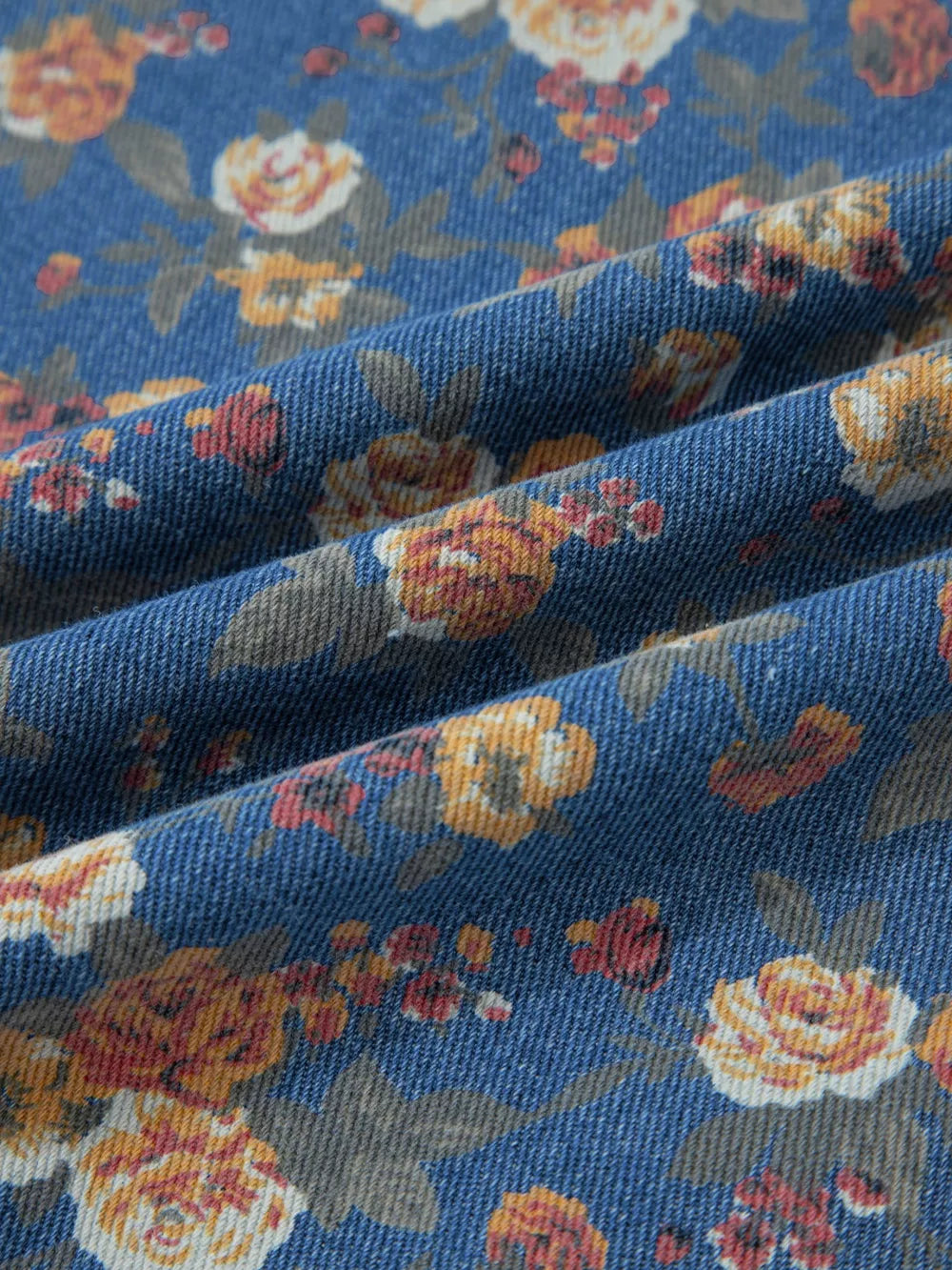 Floral denim overalls with adjustable straps and a vintage floral print.