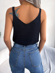 Black knit tank top with V-neck and adjustable straps, styled with blue jeans.
