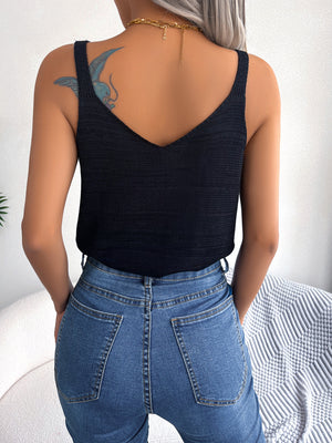 Black knit tank top with V-neck and adjustable straps, styled with blue jeans.
