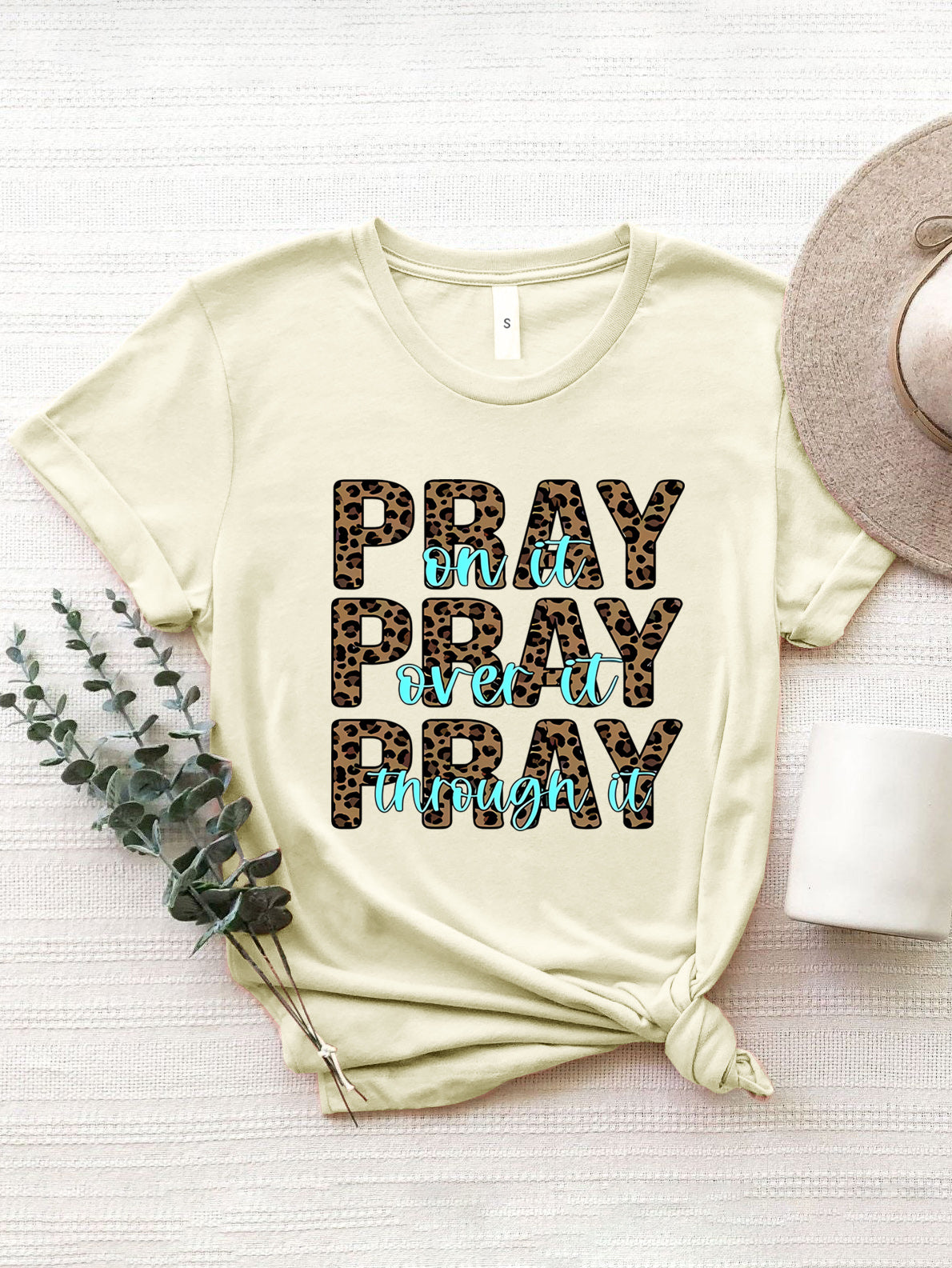 Cream leopard print graphic tee with text that says Pray on it, Pray over it, Pray through it.