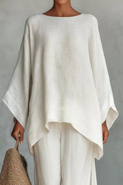 White polyester two-piece set with flowing top and wide-leg pants.