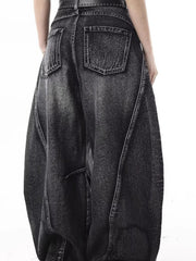 Men's dark wash distressed wide-leg jeans with a relaxed fit and visible stitching details.