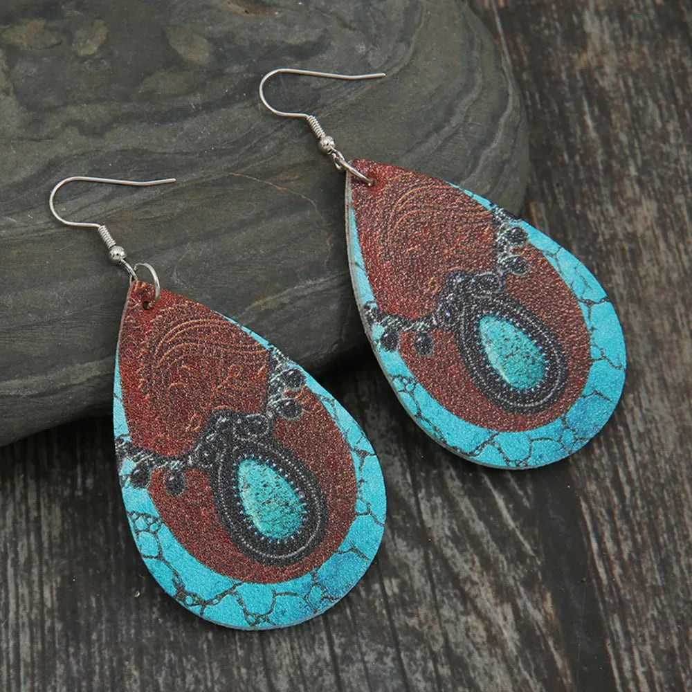 Teardrop cowhide earrings with turquoise and black accents