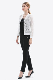 White lace-cut bomber jacket with a zip front and ribbed cuffs, styled with black pants.