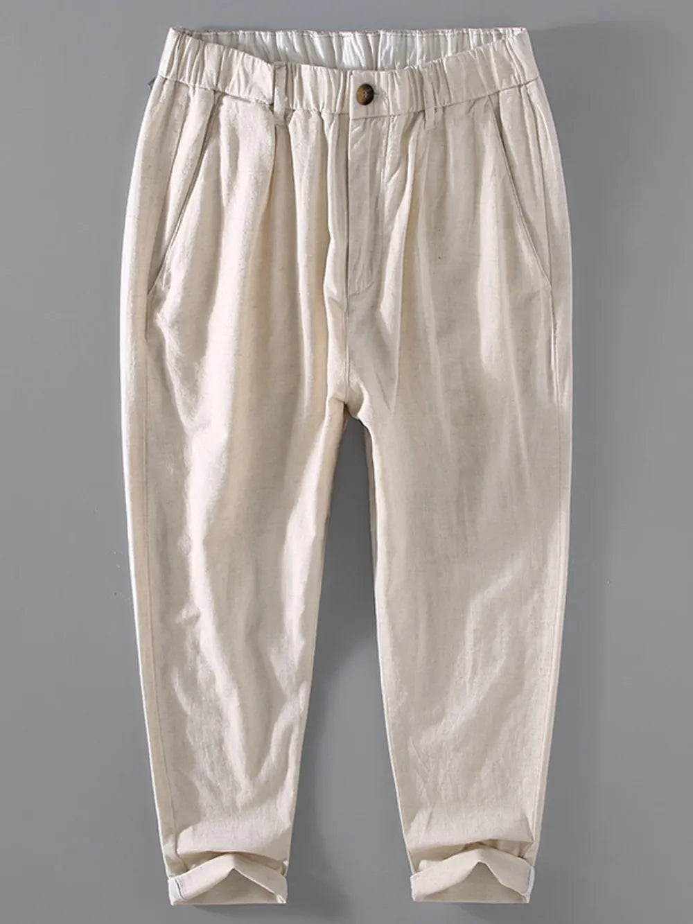 Men's beige relaxed fit cropped sweatpants with elastic waistband and cuffed hem.