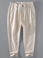 Men's beige relaxed fit cropped sweatpants with elastic waistband and cuffed hem.