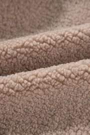 Teddy bomber jacket in mocha showing fluffy sherpa fabric texture.