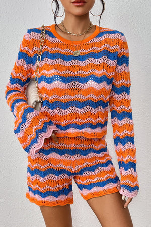Crochet flare set with orange-red, blue, and pink wavy stripes, bell sleeves, and shorts.