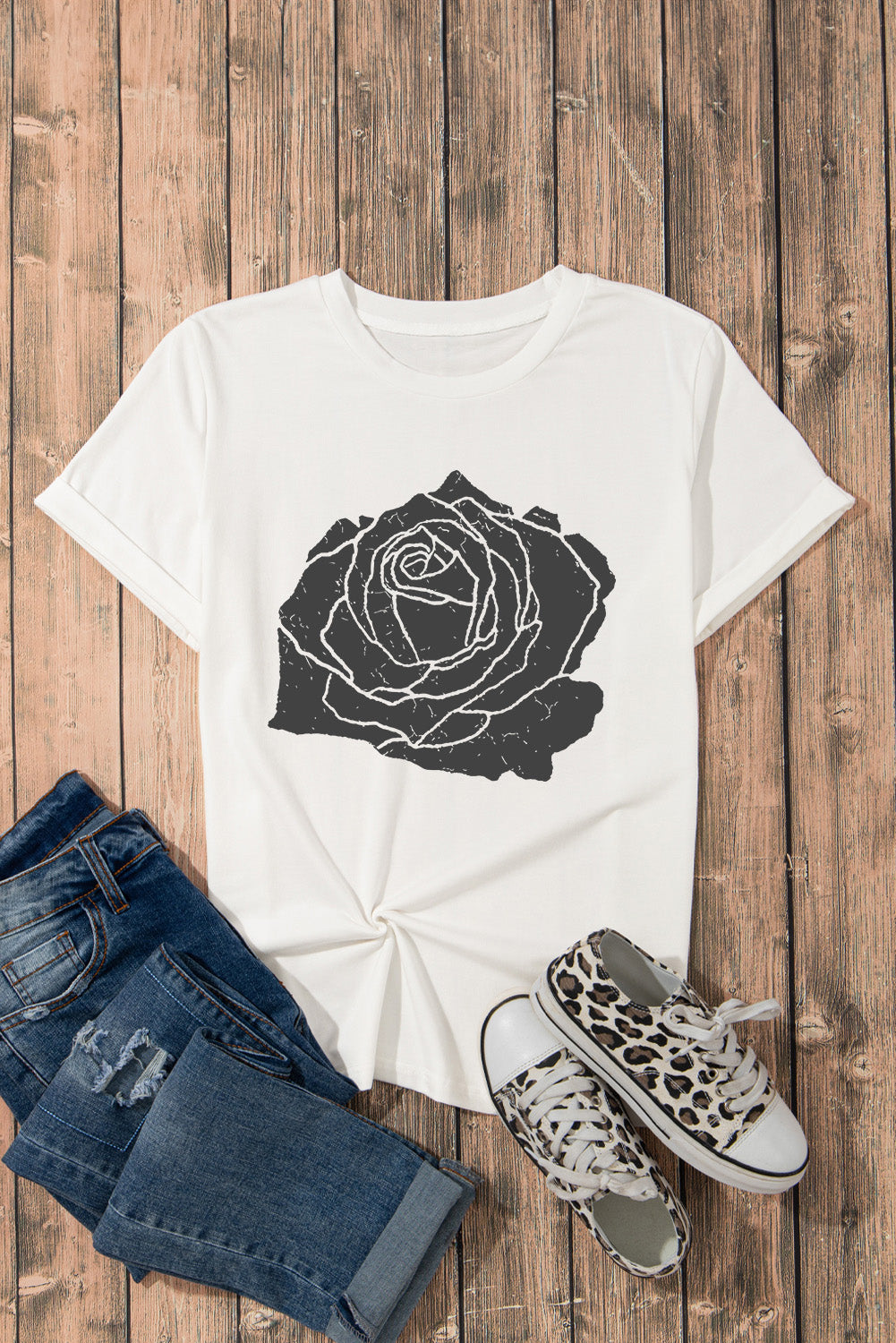 White t-shirt with distressed black rose graphic and rolled sleeves.
