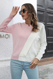 Diagonal knit sweater in blush pink and white with cable knit detail.