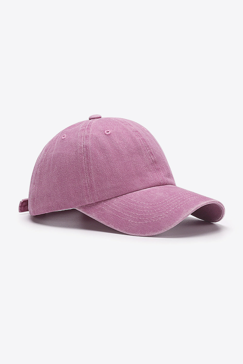 Washed cotton baseball cap in pink with adjustable strap and curved brim.