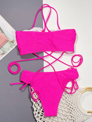 Hot pink ruched strappy bikini set with lace-up detailing.