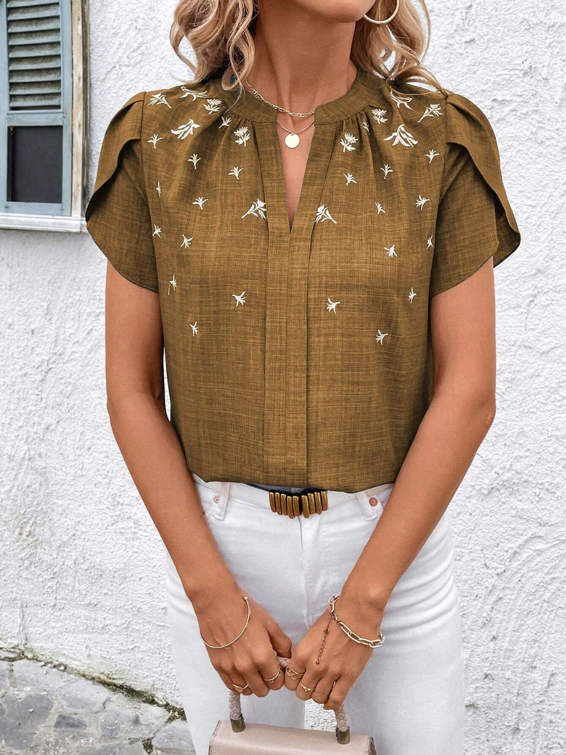 Camel embroidered floral keyhole blouse with flutter sleeves.