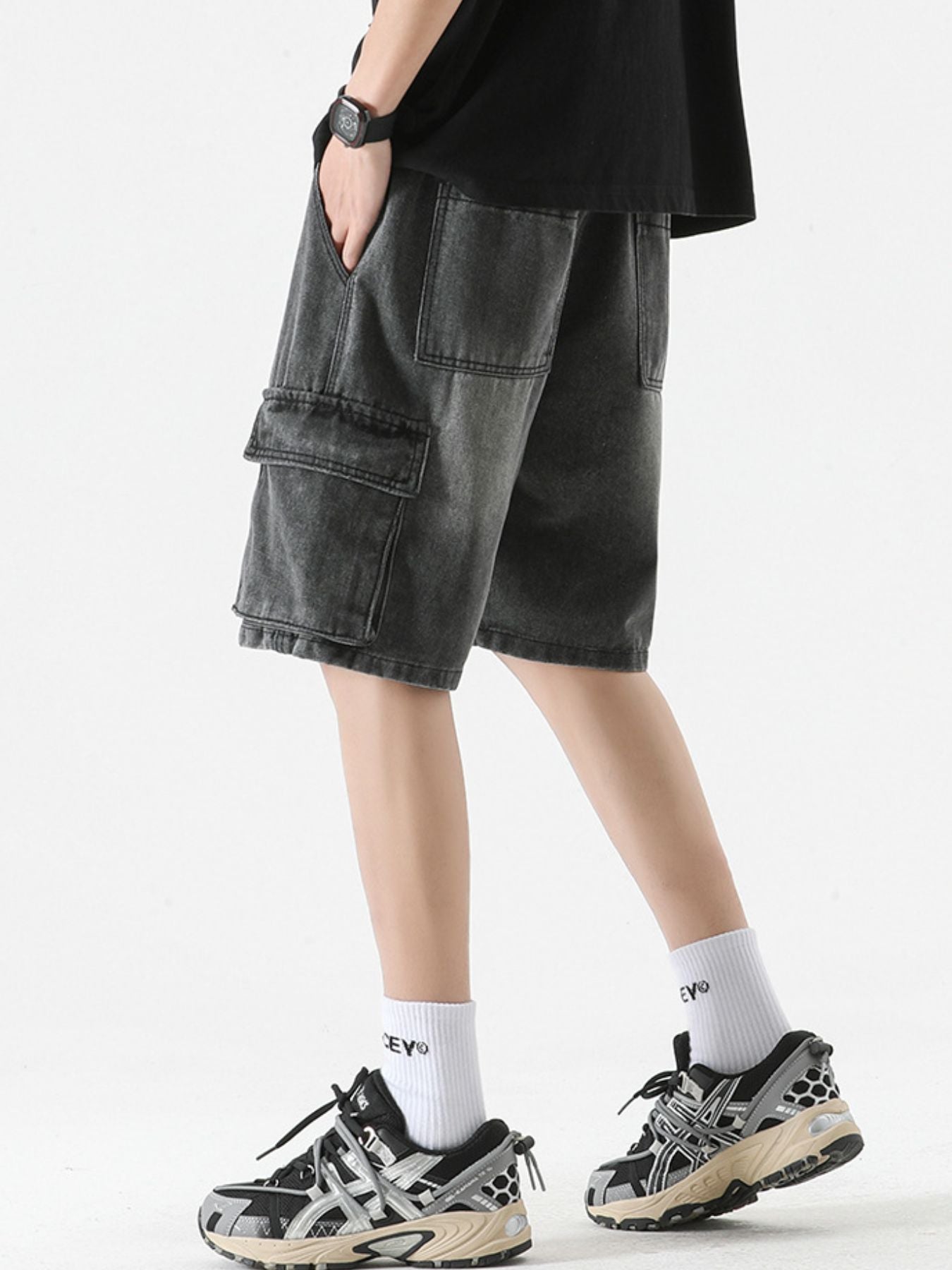 Black denim cargo shorts with drawstring and multiple pockets.