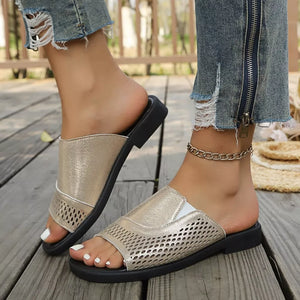 Chic gold hollow-out slide sandals with breathable perforated detail.