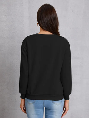 Black crewneck sweatshirt with ribbed cuffs and hem, styled with jeans.