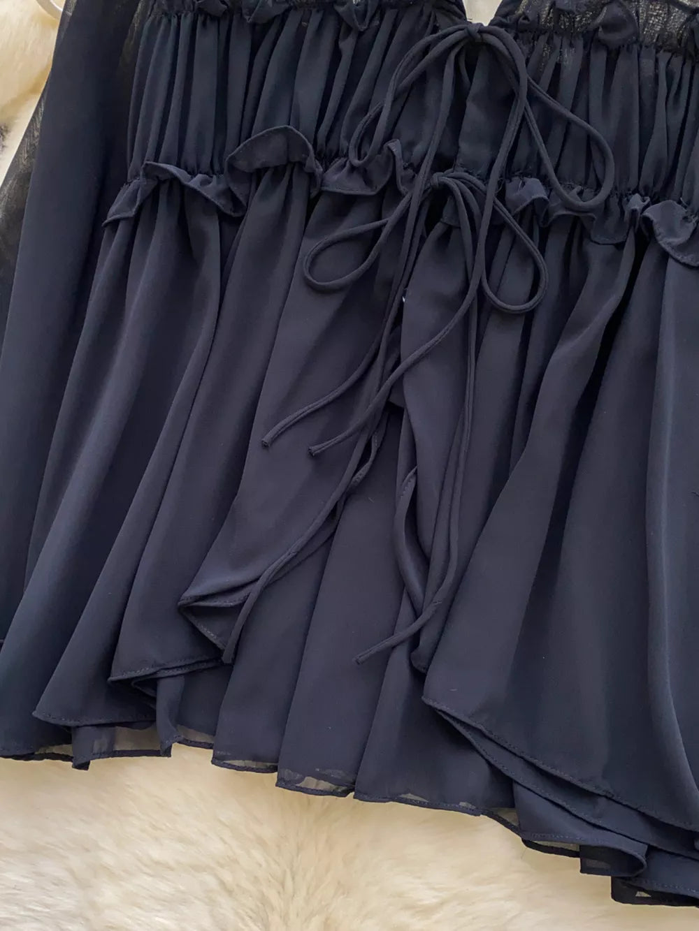 Black chiffon blouse with ruffled neckline and tie front detail