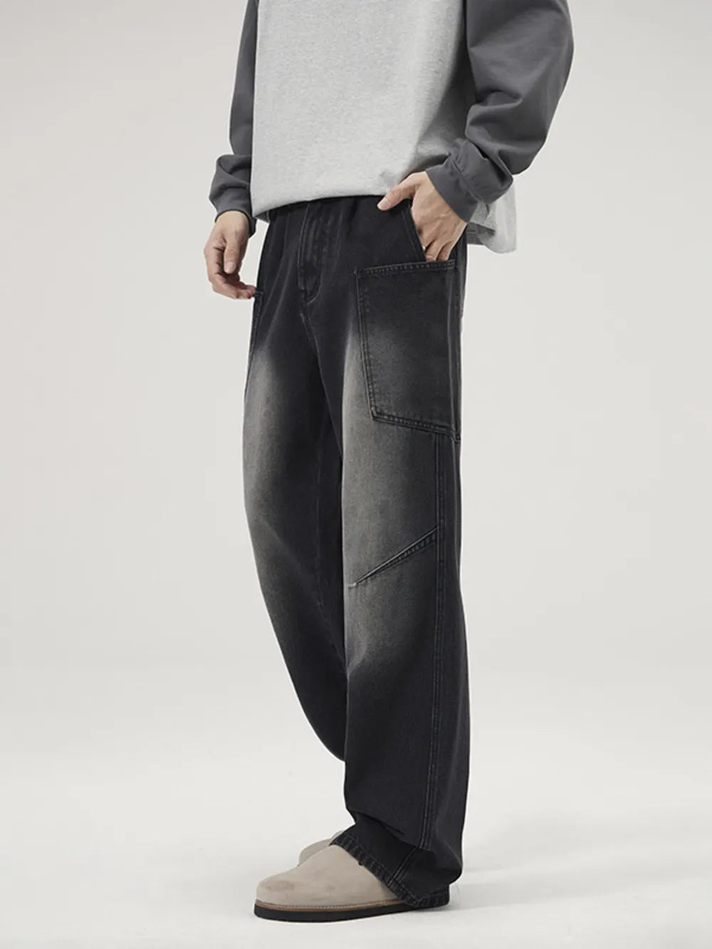 Relaxed fit black washed wide-leg jeans with a cargo pocket detail.