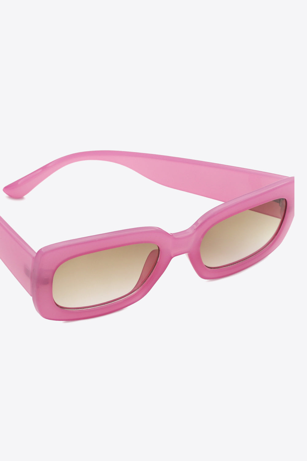 Bubblegum pink acetate rectangular sunglasses with gradient brown lenses.