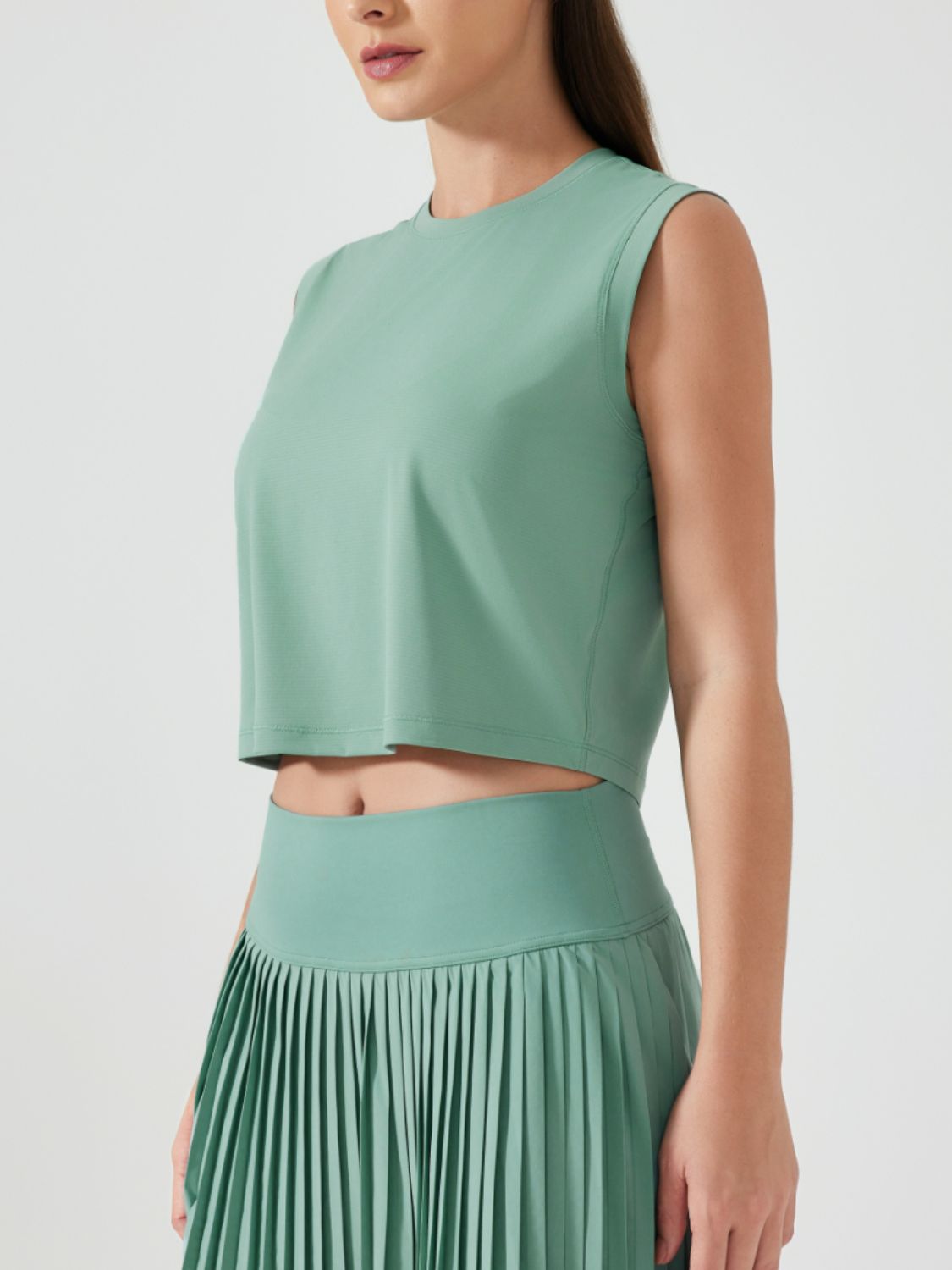 Teal sculpted crop active muscle tee with crewneck and sleeveless cut.