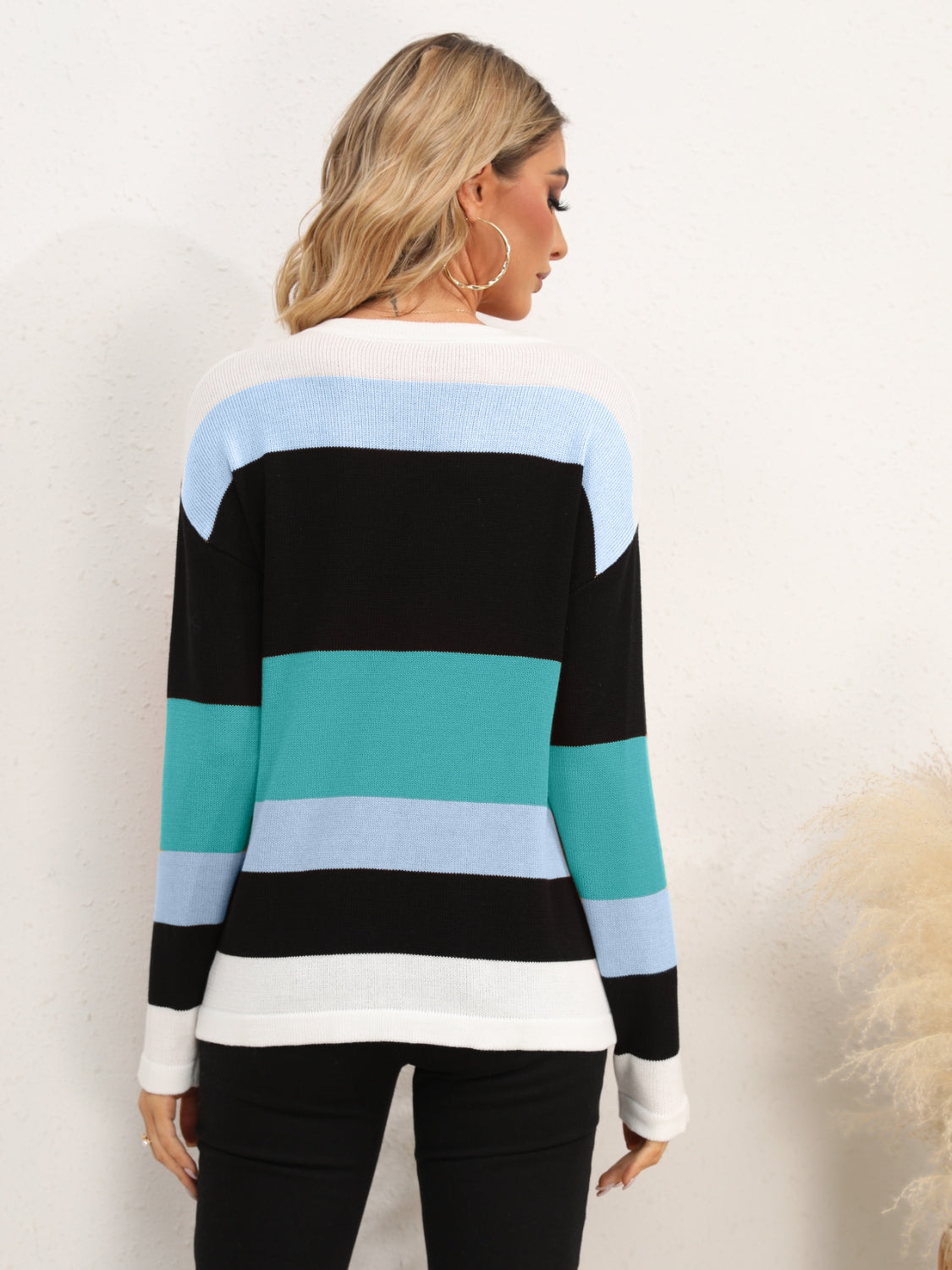 Colorblock crewneck sweater with black, teal, and light blue stripes in acrylic knit.